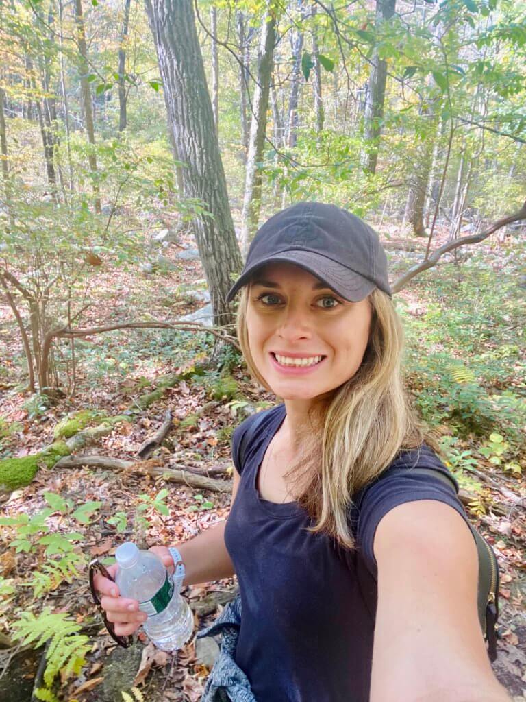 Jackie hiking in the woods as a part of her self care